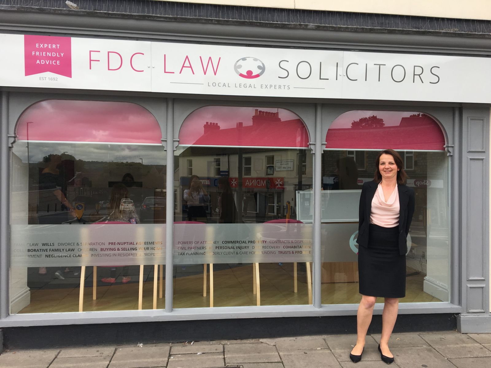 Agniezska Burfoot standing in front of FDC Law office windows