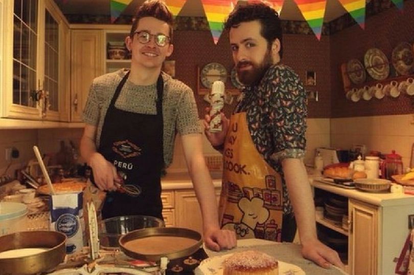 photo of two men baking, with rainbow bunting in background